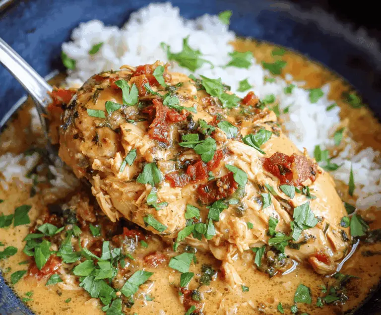 Creamy Crockpot Marry Me Chicken served in a white bowl with fresh herbs, showcasing tender, flavorful chicken in a rich sauce perfect for a romantic dinner.