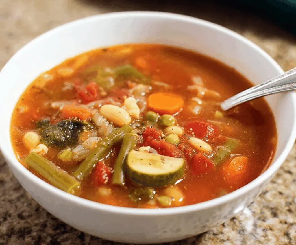 Delicious homemade Olive Garden-style vegetable soup with fresh vegetables and herbs in a bowl