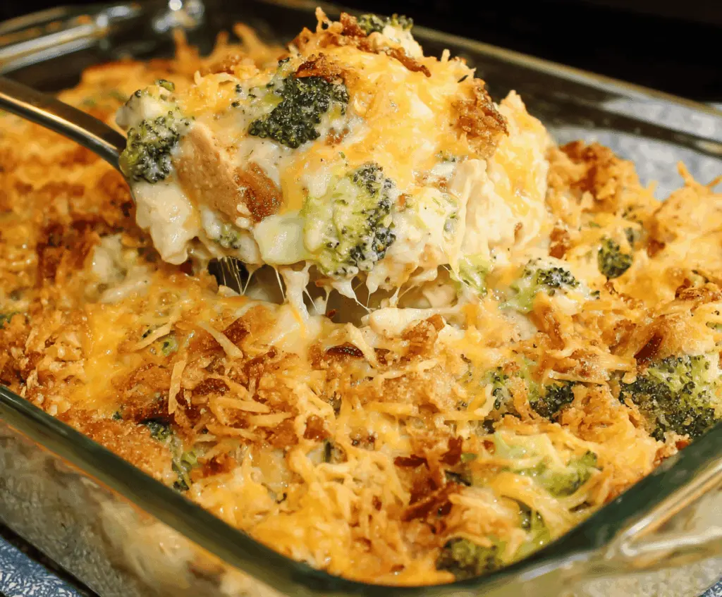 Delicious broccoli chicken casserole topped with melted cheese and fresh herbs.