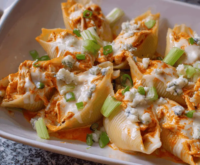 Delicious Buffalo Chicken Stuffed Shells topped with melted cheese, perfect for a spicy dinner meal