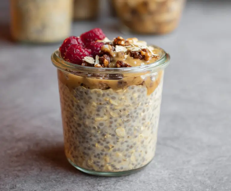 Creamy brown sugar overnight oats served in a glass jar topped with fresh berries and nuts.