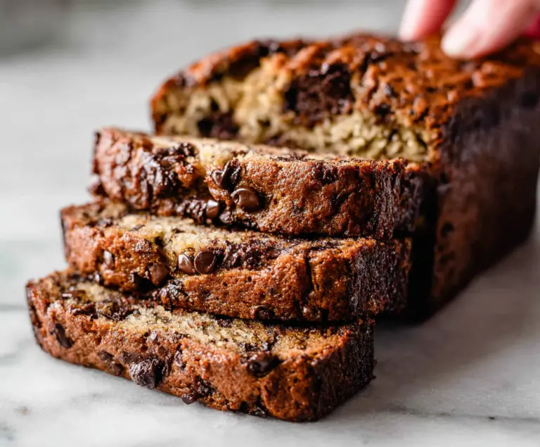 Delicious homemade chocolate chip banana bread with gooey chocolate chips and ripe bananas.