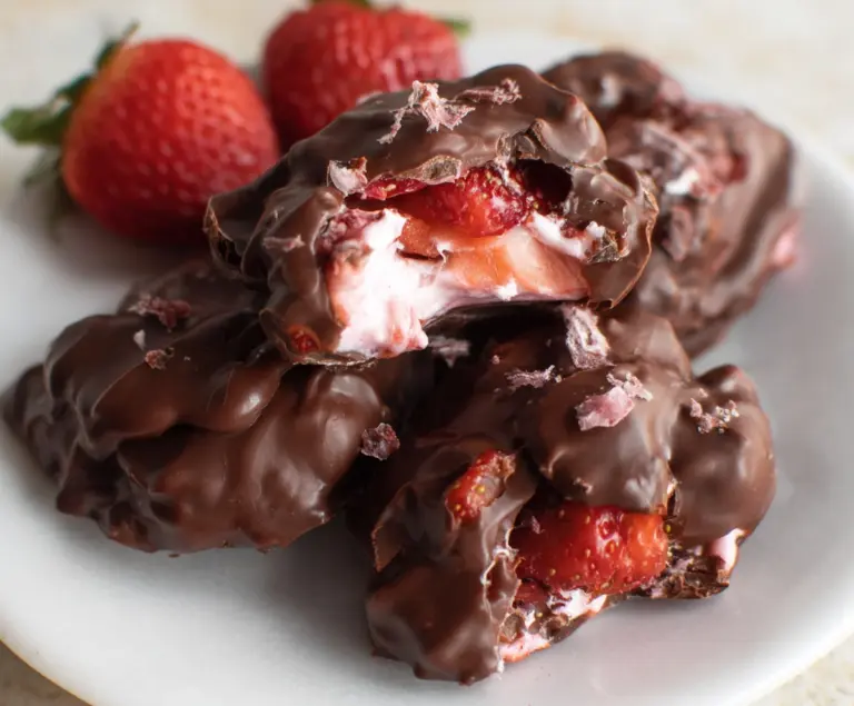 Delicious homemade chocolate strawberry yogurt clusters with rich chocolate coating and fresh strawberries.