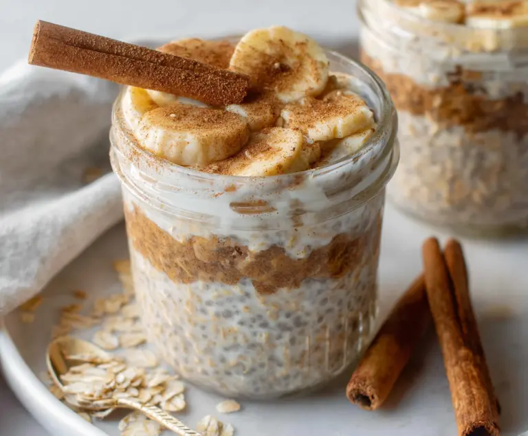Creamy cinnamon roll overnight oats topped with icing and cinnamon, perfect for a quick breakfast.