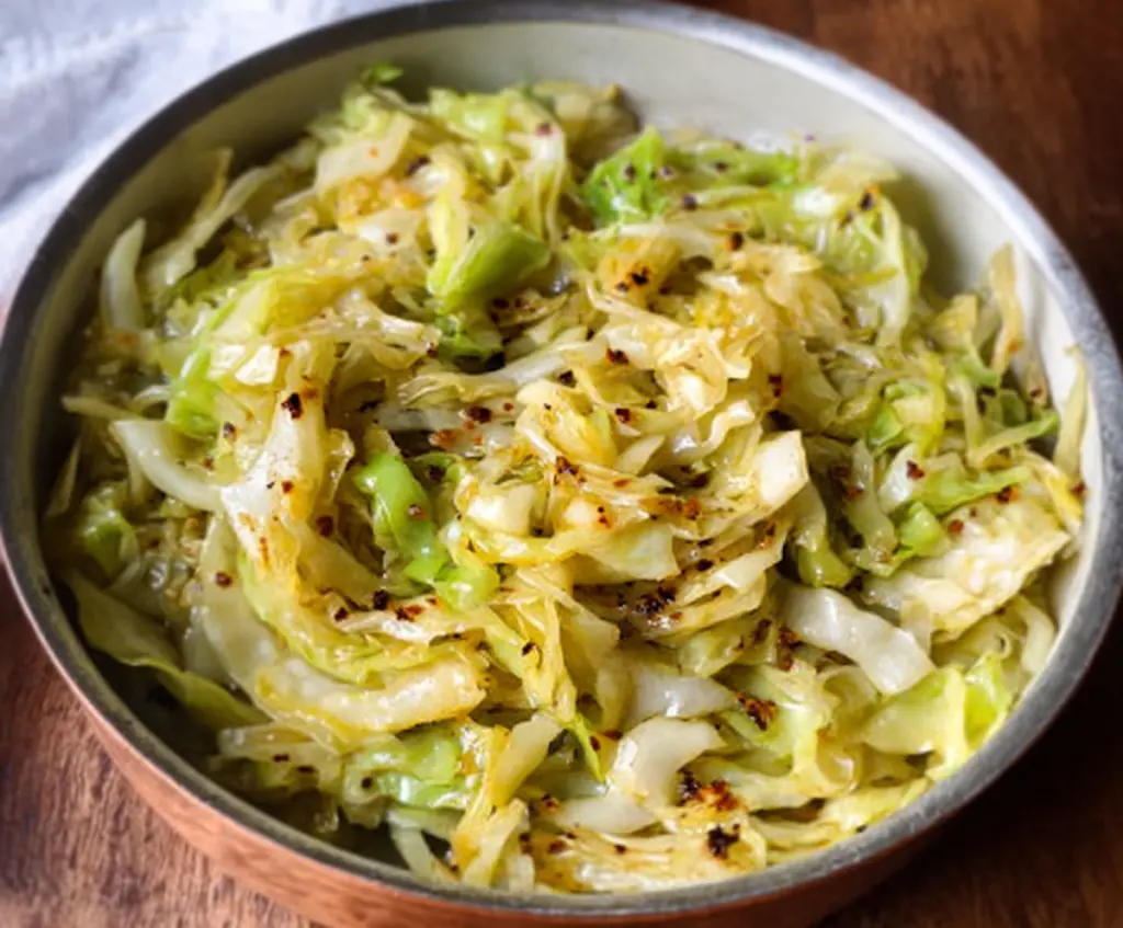 Delicious garlic butter sautéed cabbage served on a plate, highlighting a flavorful vegetable side dish.