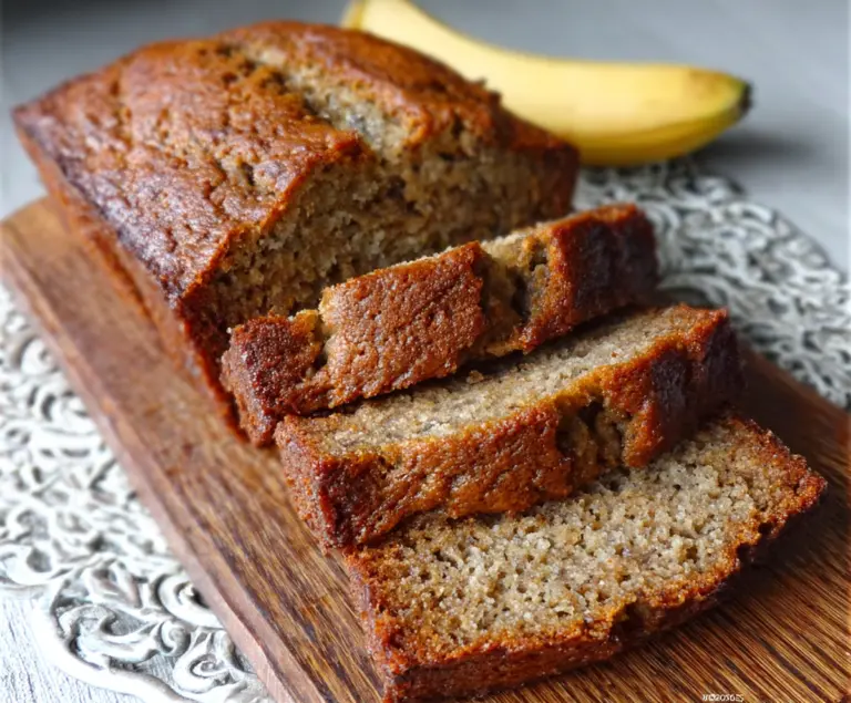 Delicious ultra-moist classic banana bread fresh out of the oven with a golden crust.