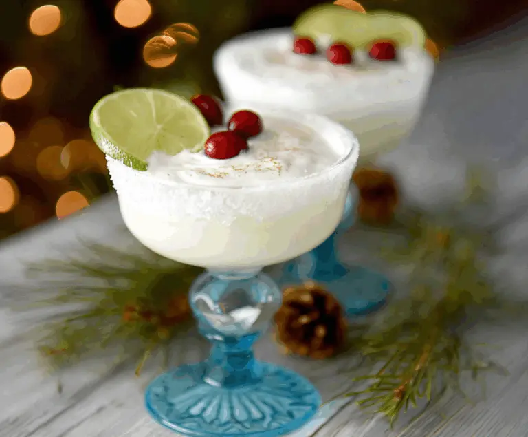 A festive White Christmas Margarita with a salted rim and sugared ornament, perfect for holiday celebrations.