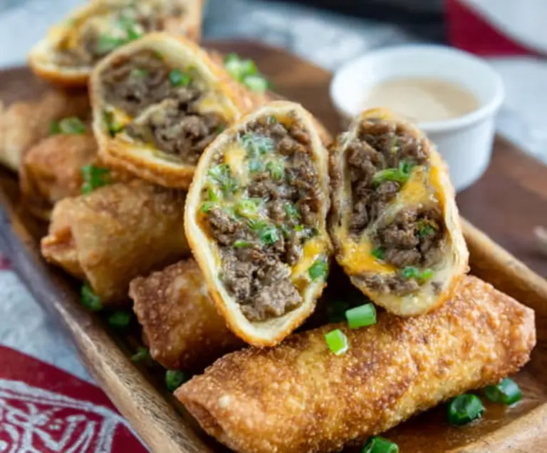 Delicious Philly Cheesesteak Egg Rolls showing crispy exterior filled with savory steak and melted cheese.