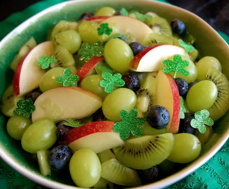 Vibrant St. Patrick’s Day green fruit salad with colorful fresh fruits in a bowl for a festive celebration.