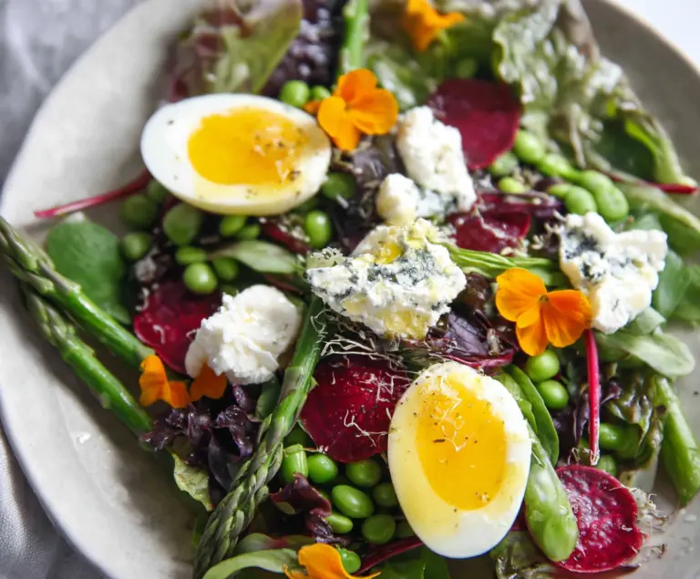 Colorful Easter Spring Salad with goat cheese, fresh vegetables, and vibrant herbs.