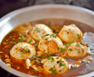 Close-up of a perfectly boiled egg in an eggshell, showing smooth white and round shape