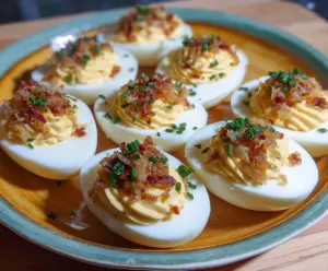 French Onion Deviled Eggs garnished with caramelized onions and fresh herbs.