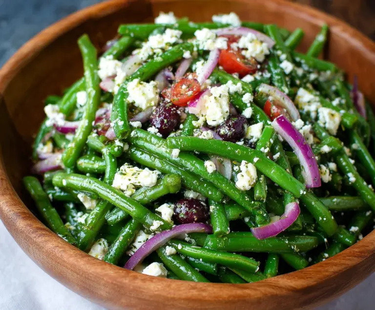 Fresh green bean and feta salad in a bowl, garnished with herbs for a healthy appetizer.